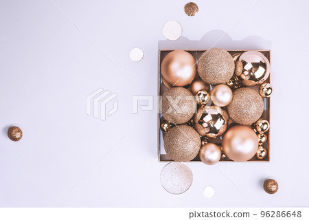 Christmas golden decorations, balls on light pastel background 96286648