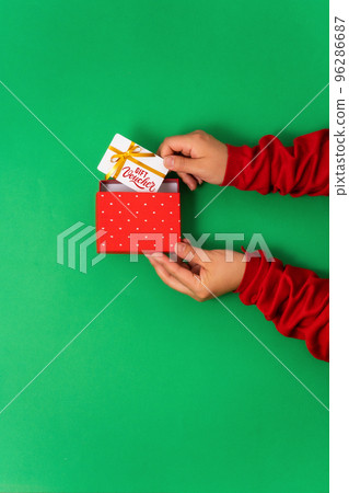 Female hands take out gift voucher from gift box, online services and shopping 96286687