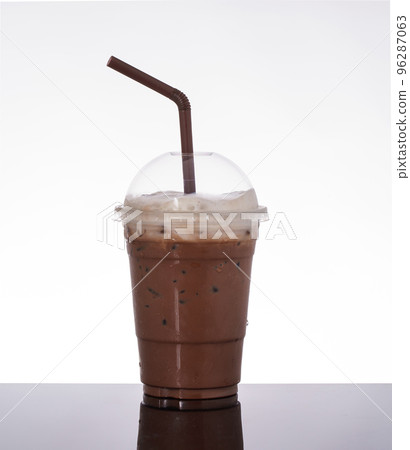 Delicious iced cocoa in takeaway glass, topped with milk foam, on white background and black glass floor. 96287063