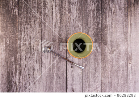 Clay mate calabash with bombilla on grey wood background 96288298