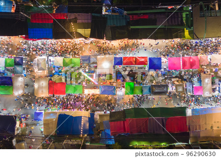 Aerial top view of amusement park in night temple fair, and night local markets. People walking street, Colorful tents in Bangkok city, Thailand. Retail shops 96290630