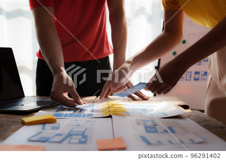 Group of ux developer and ui designer brainstorming about app interface design at modern office. Creative digital development agency 96291402