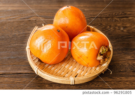 persimmons in a basket persimmons in a basket 96291805