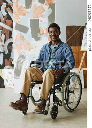Young confident artist or craftsman in wheelchair sitting in front of camera Young confident artist or craftsman in wheelchair sitting in front of camera 96293571