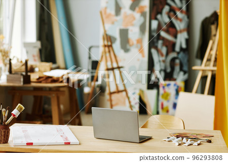 Laptop standing among bunch of paintbrushes and tubes with acrylic paints Laptop standing among bunch of paintbrushes and tubes with acrylic paints 96293808