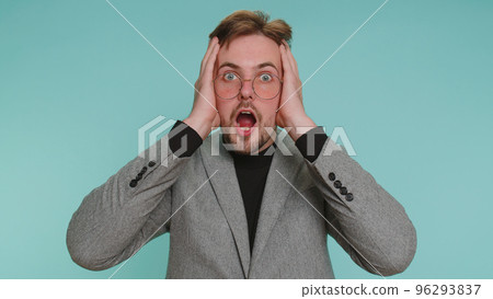 Amazed business man surprise looking at camera with big eyes, shocked by sudden victory, wow emotion 96293837