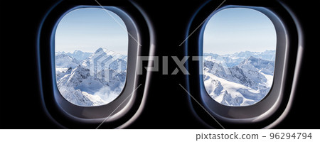 Mountains view through jet plane windows high on the sky. Winter snowy mountains Mountains view through jet plane windows high on the sky. Winter snowy mountains 96294794