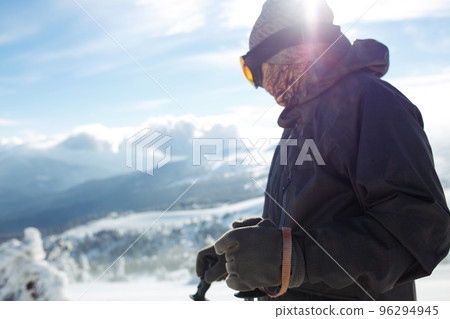 Man skiing in the mountains. Skiing in the snowy mountains, Winter is coming, snowfall. Active lifestyle. Man skiing in the mountains. Skiing in the snowy mountains, Winter is coming, snowfall. Active lifestyle. 96294945