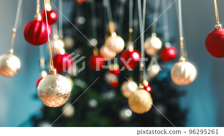 Christmas tree balls swinging in front of the tree Christmas tree balls swinging in front of the tree 96295261