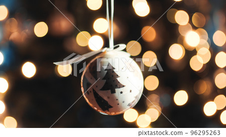 Hanging the White Christmas ball on the tree point of view Hanging the White Christmas ball on the tree point of view 96295263