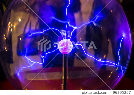 Plasma ball with smooth magenta-blue flames on a dark background. Plasma ball with smooth magenta-blue flames on a dark background. 96295297