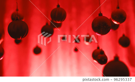 Silhouette of Christmas balls swinging against red background 96295337