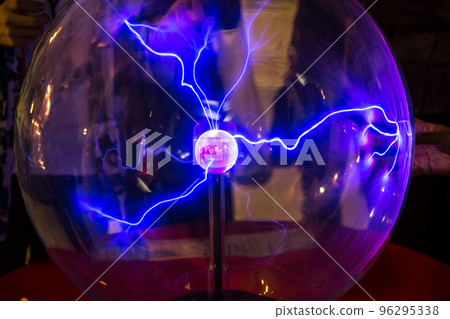 Plasma ball with smooth magenta-blue flames on a dark background. Plasma ball with smooth magenta-blue flames on a dark background. 96295338