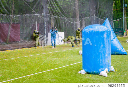 paintball sport player in protective uniform and mask playing with gun outdoors paintball sport player in protective uniform and mask playing with gun outdoors 96295655
