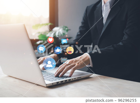 Chat and notification on notebook with emoji social media icon. businessman hand typing laptop on vacation with hologram. Social media and digital online concept. 96296255