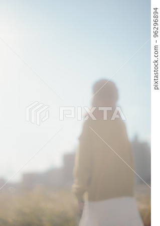 Photo of a young woman standing by a riverbed 96296894