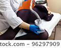Anti-cellulite massage procedure in the cosmetologist's office. LPG massage for slender and beautiful women's legs. 96297909