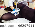 Anti-cellulite massage procedure in the cosmetologist's office. LPG massage for slender and beautiful women's legs. 96297911