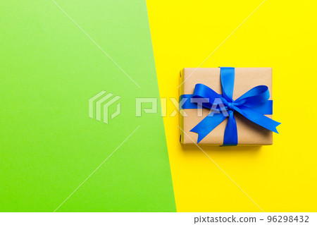 holiday handmade paper present tied blue ribbon bow top view with copy space. Flat lay holiday background. Birthday or christmas present. Christmas gift box concept with copy space 96298432