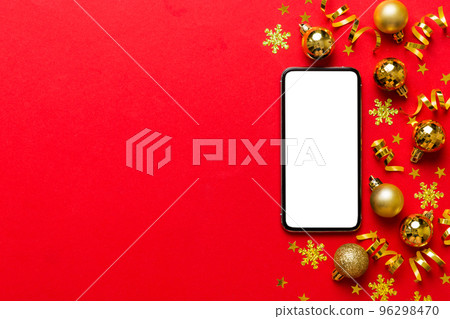 Christmas online shopping from home phone with blank white display top view. smart mobile with copy space on colored background with Christmas decorations balls,. Winter holidays sales background Christmas online shopping from home phone with blank white display top view. smart mobile with copy space on colored background with Christmas decorations balls,. Winter holidays sales background 96298470