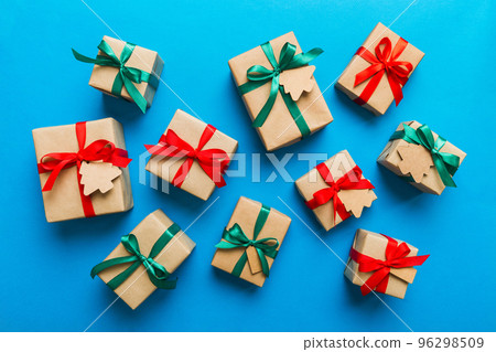 Colored craft gift boxes with colorful ribbons on colored background. Collection of Christmas present boxes Colored craft gift boxes with colorful ribbons on colored background. Collection of Christmas present boxes 96298509