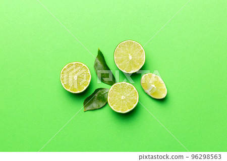 Lime fruits with green leaf and cut in half slice isolated on white background. Top view. Flat lay with copy space Lime fruits with green leaf and cut in half slice isolated on white background. Top view. Flat lay with copy space 96298563