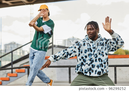 Two young men dancing outdoors 96299252