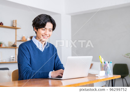 A young man teleworking at home A young man teleworking at home 96299752