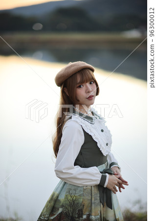A beautiful woman in lolita dress in garden background Japanese street fashion portrait 96300012