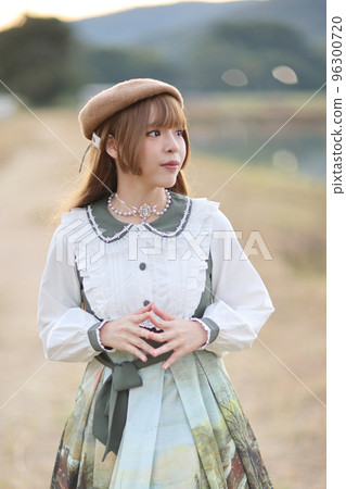 A beautiful woman in lolita dress in garden background Japanese street fashion portrait A beautiful woman in lolita dress in garden background Japanese street fashion portrait 96300720