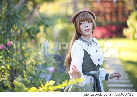 A beautiful woman in lolita dress in garden background Japanese street fashion portrait A beautiful woman in lolita dress in garden background Japanese street fashion portrait 96300722