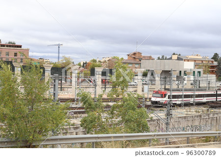 Train. Train tracks. Train entering a station. Subway leaving the station. Means of transport in Madrid, in Spain. Horizontal photography. 96300789