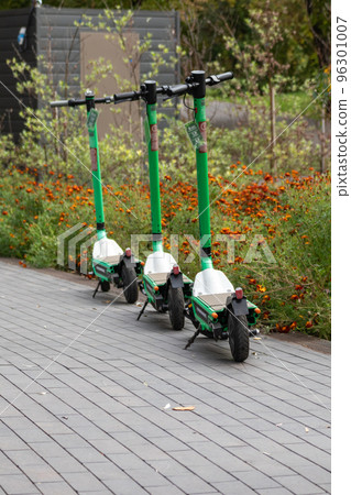 Electric Scooters rental parked in autumn city Electric Scooters rental parked in autumn city 96301007