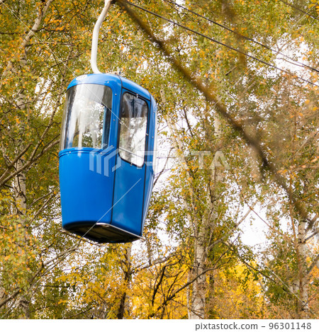 Blue cableway cabin in autumn golden forest Blue cableway cabin in autumn golden forest 96301148