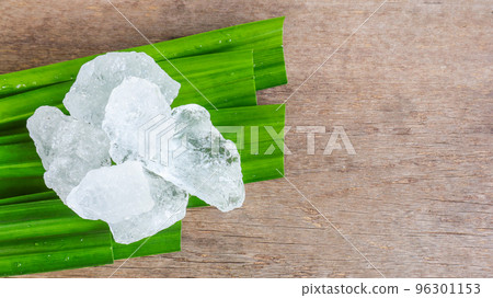 Crystal clear alum cubes or Potassium alum on green leaf Chemical compound substance Concept for beauty spa and underarm treatment industrial                            96301153