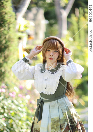 A beautiful woman in lolita dress in garden background Japanese street fashion portrait A beautiful woman in lolita dress in garden background Japanese street fashion portrait 96301441