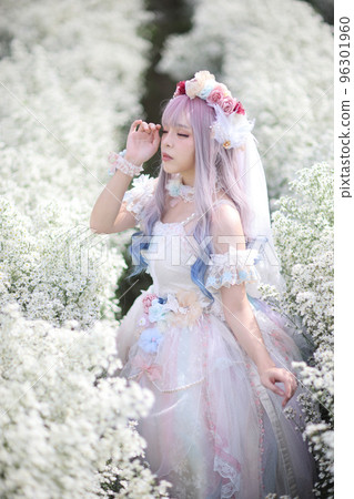 Portrait of Asian young woman with lolita fashion dress in white flower garden background 96301960