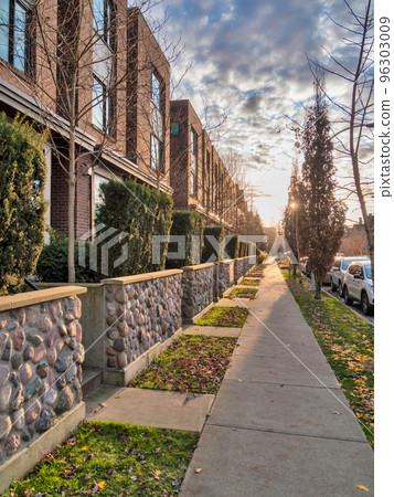 Sidewalk along townhouses on autumn season in Queensborough community Sidewalk along townhouses on autumn season in Queensborough community 96303009