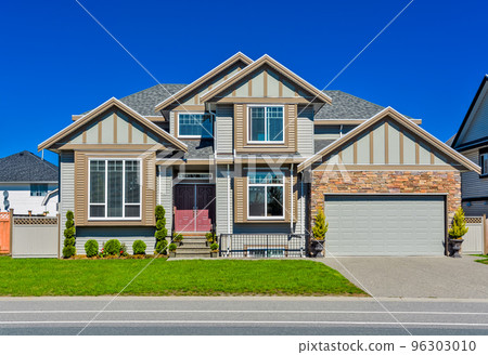 Suburban family house with green lawn in front Suburban family house with green lawn in front 96303010