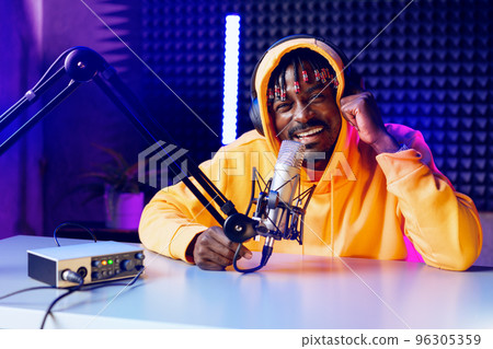 Happy young african man audio blogger broadcasting at studio Happy young african man audio blogger broadcasting at studio 96305359