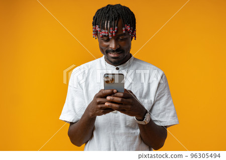 Young african man using smartphone over isolated yellow background 96305494