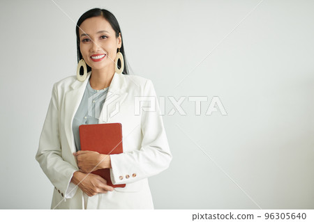 Portrait of smiling elegant businesswoman holding tablet computer, isolated on white Portrait of smiling elegant businesswoman holding tablet computer, isolated on white 96305640