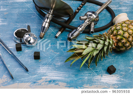 Parts of hookah and fruits on wooden background Parts of hookah and fruits on wooden background 96305938