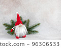Christmas dwarf in red hat with fir branch holiday card on light winter background 96306533