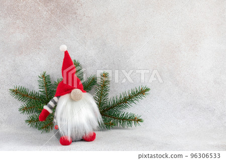 Christmas dwarf in red hat with fir branch holiday card on light winter background 96306533