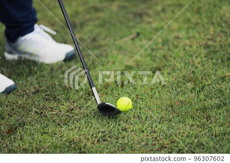 Golf ball on green grass ready to be struck on grass background 96307602