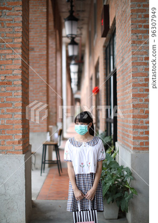 Portrait young woman with mask shopping at community mall on urban in covid-19 virus outbreak 96307949