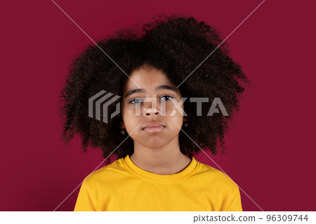 Portrait of curly black child over colorful background Portrait of curly black child over colorful background 96309744