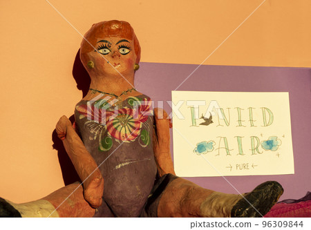 antique paper doll next to a sign 96309844