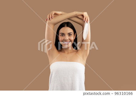 Image of attractive half-naked woman holding white feather 96310166